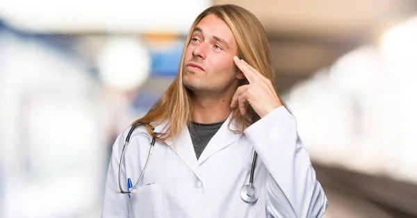 Doctor man with problems making suicide gesture in a hospital