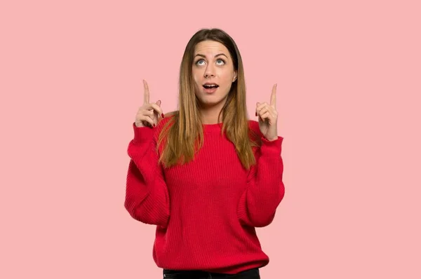 Young Woman Red Sweater Pointing Surprised Isolated Pink Background — Stock Photo, Image