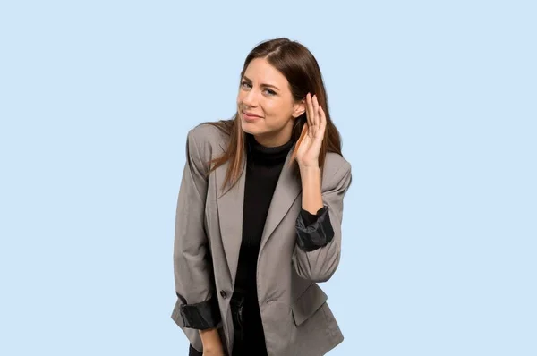 Biznes Kobieta Słuchając Coś Kładąc Rękę Ucho Białym Tle Niebieski — Zdjęcie stockowe