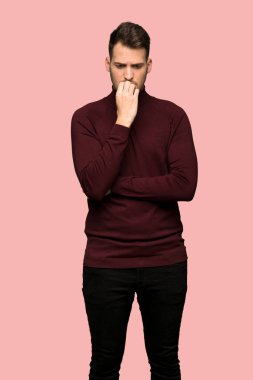 Man with turtleneck sweater having doubts over pink background clipart
