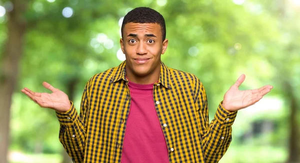 Young Afro American Man Having Doubts While Raising Hands Shoulders — Stock Photo, Image