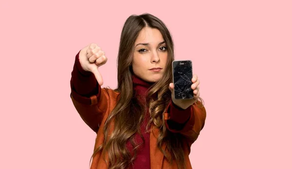 Fiatal Kabátot Zavaros Gazdaság Törött Smartphone Mint Elszigetelt Rózsaszín Háttér — Stock Fotó