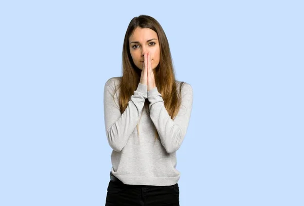 Young Girl Keeps Palm Together Person Asks Something Blue Background — Stock Photo, Image