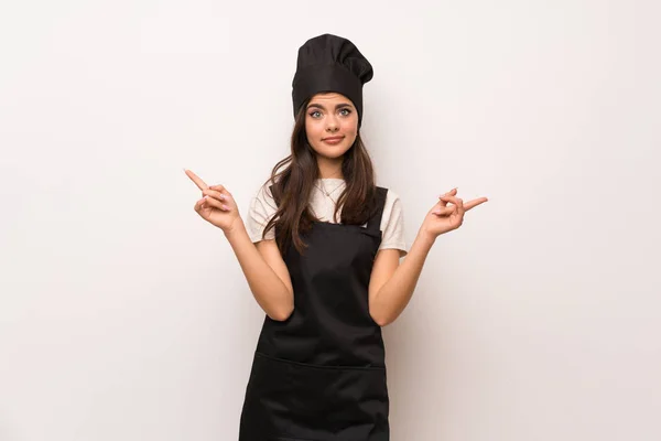 Teenager Chef White Wall Pointing Laterals Having Doubts — Stock Photo, Image