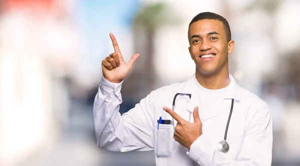 Young Afro American Man Doctor Pointing Index Finger Looking Outdoors — Stock Photo, Image