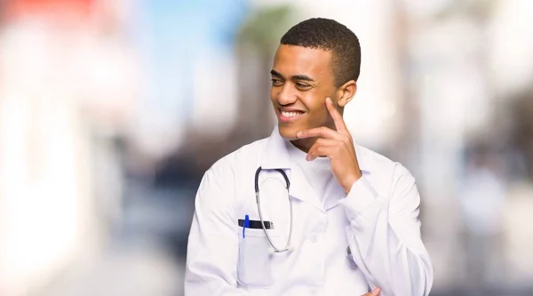 Young Afro American Man Doctor Looking Side Hand Chin Outdoors — Stock Photo, Image