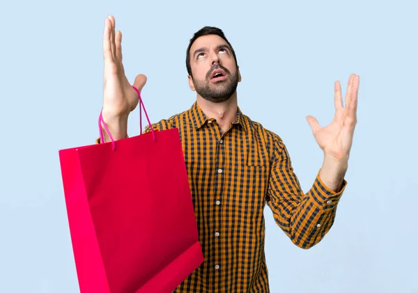 Man Shopping Bags Frustrated Bad Situation Isolated Blue Background — Stock Photo, Image