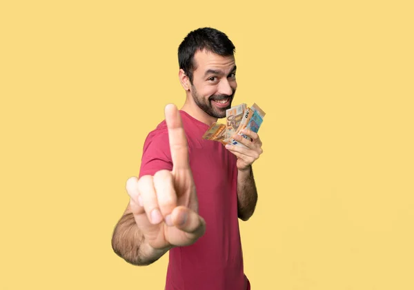 Ember Vesz Egy Csomó Pénzt Mutatja Emelési Ujját Elszigetelt Sárga — Stock Fotó