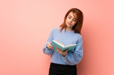 Bir kitap ve okuma zevk pembe genç Kızıl saçlı kadın