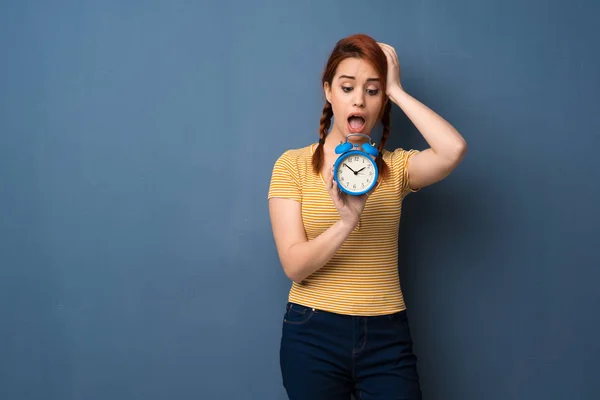 Young Redhead Woman Blue Background Restless Because Has Become Late — Stock Photo, Image