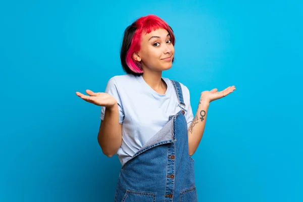 Young Woman Pink Hair Blue Wall Making Doubts Gesture — Stock Photo, Image