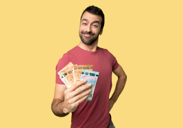 Hombre Tomando Montón Dinero Posando Con Los Brazos Cadera Sonriendo — Foto de Stock