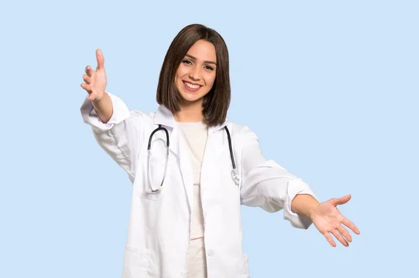 Jonge Dokter Vrouw Presenteren Uitnodigen Komen Met Hand Geïsoleerde Blauwe — Stockfoto