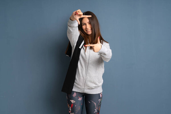 Young sport woman focusing face. Framing symbol