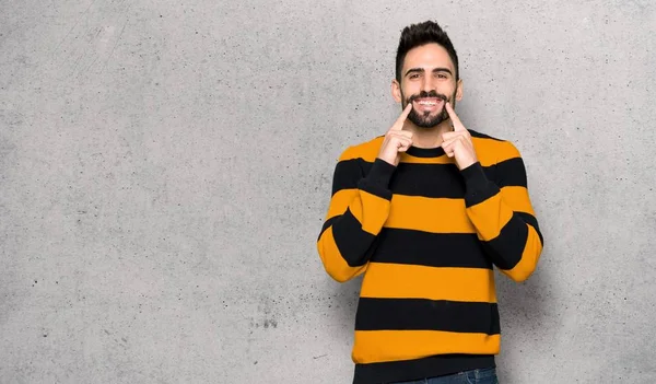 Handsome Man Striped Sweater Smiling Happy Pleasant Expression Textured Wall — Stock Photo, Image