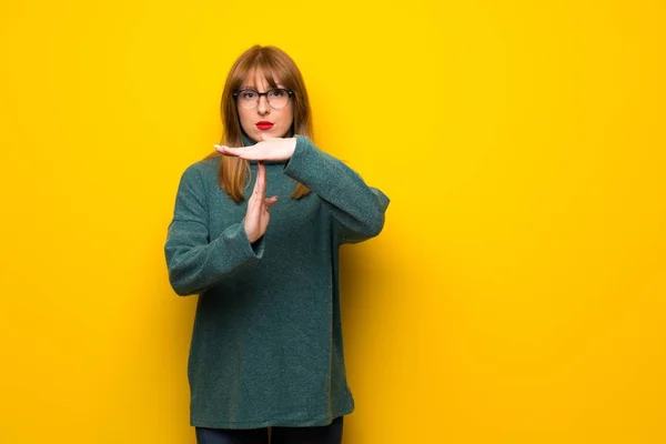 Vrouw Met Een Bril Gele Muur Maken Stop Gebaar Met — Stockfoto