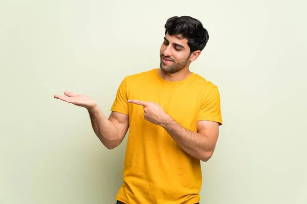 Young Man Pink Wall Holding Copyspace Imaginary Palm Insert — Stock Photo, Image