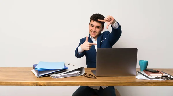 Business man in a office focusing face. Framing symbol