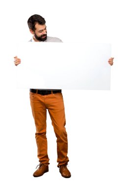 Boş bir afiş tutarak sakallı yakışıklı adam