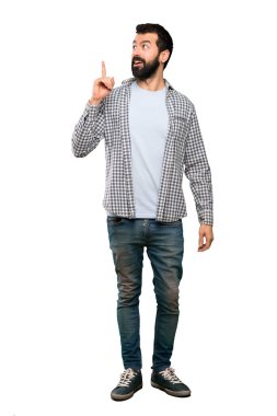 İzole beyaz arka plan üzerinde parmak işaret bir fikir düşünce sakallı yakışıklı adam
