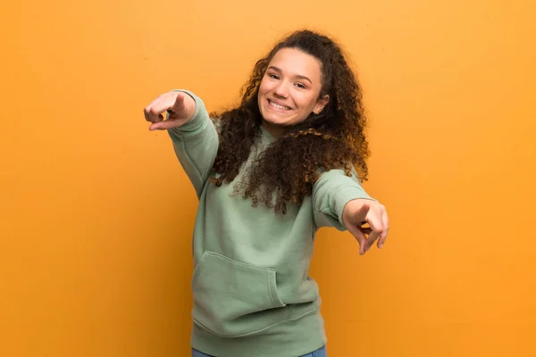 Adolescente Chica Sobre Ocre Pared Señala Dedo Usted Mientras Sonríe —  Fotos de Stock