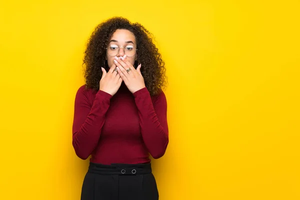 stock image Dominican woman with turtleneck sweater covering mouth with hands for saying something inappropriate