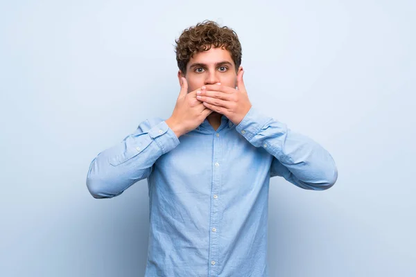 Blonde Man Blue Wall Covering Mouth Hands — Stock Photo, Image
