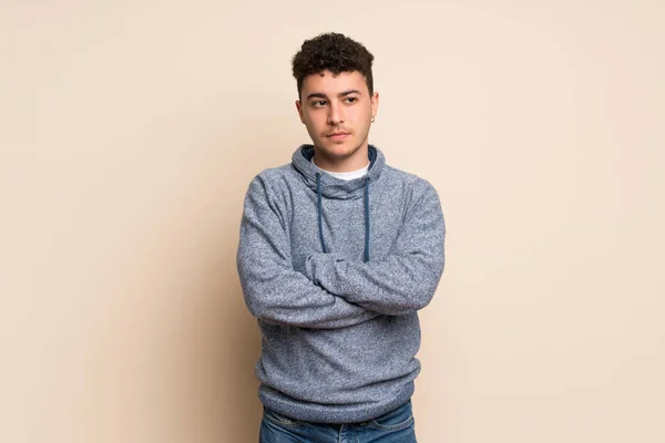 Young man over isolated wall portrait