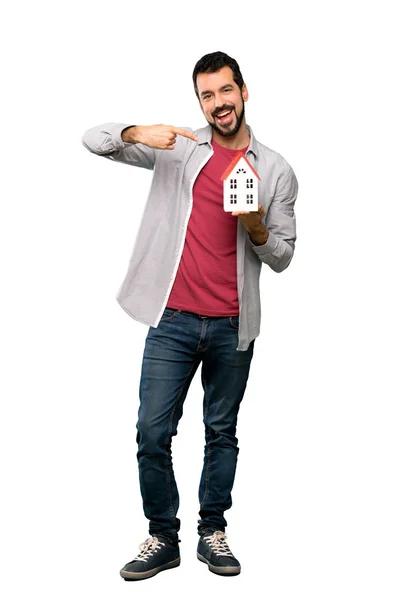 Handsome man with beard  holding a little house — Stock Photo, Image