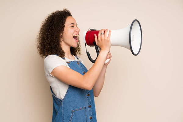 Dominican woman with overalls shouting through a megaphone