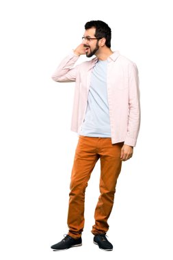 Tam uzunlukta kadeh bir şey izole beyaz arka plan üzerinde kulak el koyarak dinleme sakallı yakışıklı adam