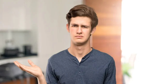 Teenager man unhappy because not understand something at indoors