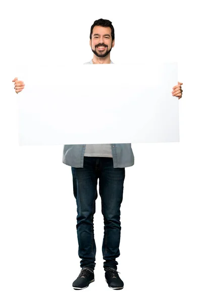 Hombre guapo con barba sosteniendo un cartel vacío —  Fotos de Stock