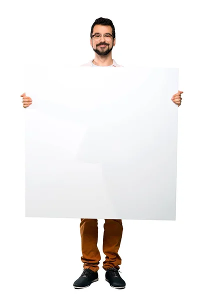 Handsome man with beard holding an empty placard — Stock Photo, Image