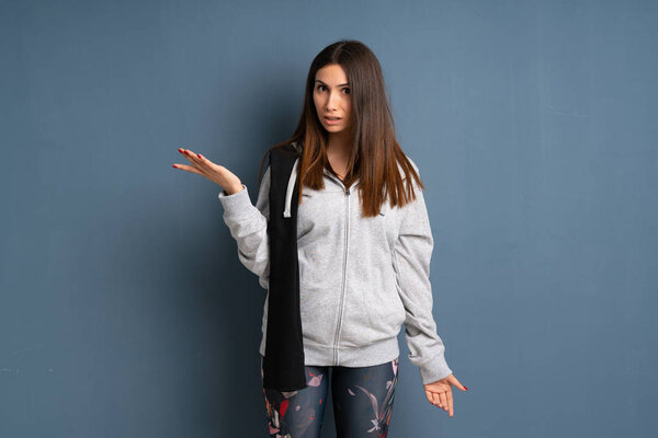 Young sport woman making doubts gesture