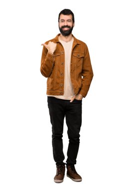 Ürün yalıtılmış beyaz arka plan üzerinde sunmak için tarafına işaret eden sakallı yakışıklı adam