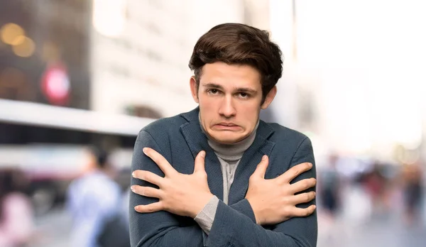 Teenager man with turtleneck freezing at outdoors