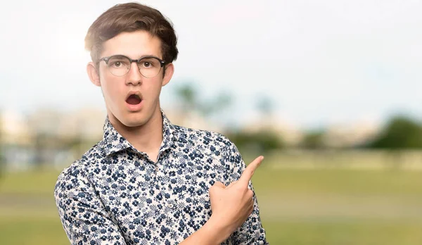 Teenager Man Flower Shirt Glasses Surprised Pointing Side Outdoors — Stock Photo, Image