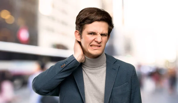 Teenager man with turtleneck having doubts at outdoors