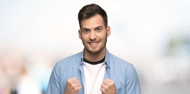 Yakışıklı adam açık havada konumda kazanan bir zaferini kutluyor