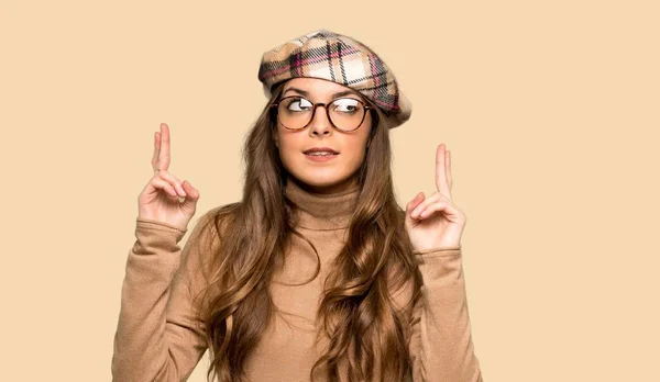 Young Woman Beret Fingers Crossing Wishing Best Isolated Yellow Background — Stock Photo, Image