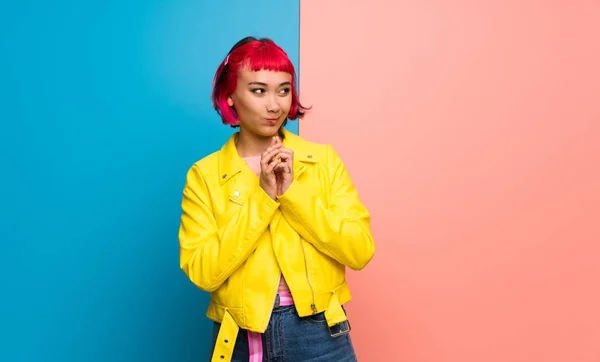 Young woman with yellow jacket scheming something