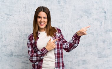 Dokulu duvar üzerinde genç kadın tarafına parmak işaret