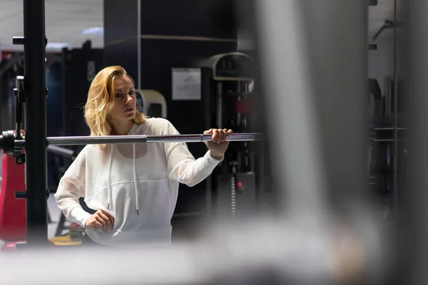 Happy Sport Woman in a gym making weightlifting