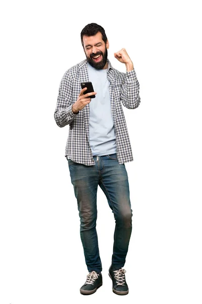 Hombre Guapo Con Barba Con Teléfono Posición Victoria Sobre Fondo —  Fotos de Stock