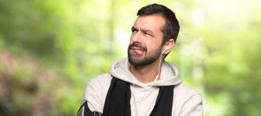 Bir parkta ısırık dudak iken yüz ifadesi karıştırır ile spor adam