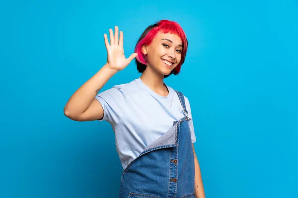 Young Woman Pink Hair Blue Wall Saluting Hand Happy Expression — Stock Photo, Image