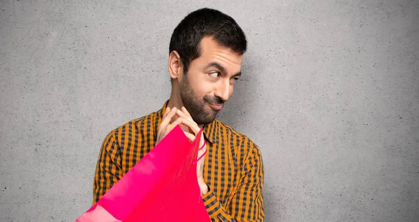 Pria Dengan Tas Belanja Licik Sesuatu Atas Dinding Bertekstur — Stok Foto