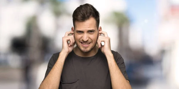 Man Black Shirt Frustrated Covering Ears Hands Outdoors — Stock Photo, Image