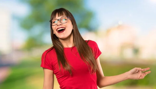 Woman with glasses with surprise facial expression at outdoors